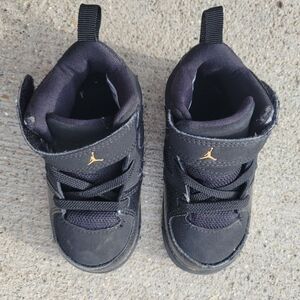 Kids Jordan Black and Gold Sneakers